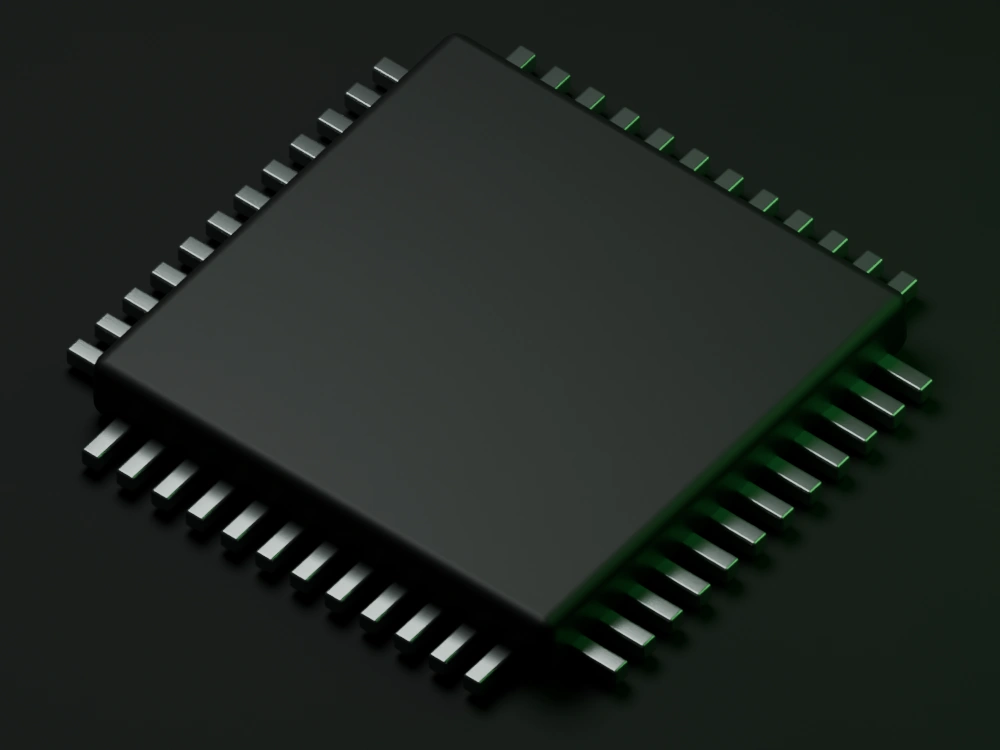 An isolated black microcontroller with metal terminals and subtle green edge lighting